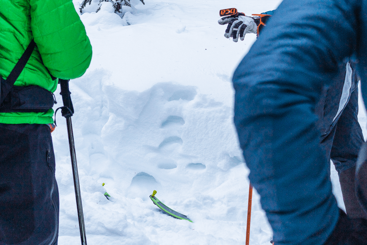 Pausing to assess snowpack on backcountry tour.