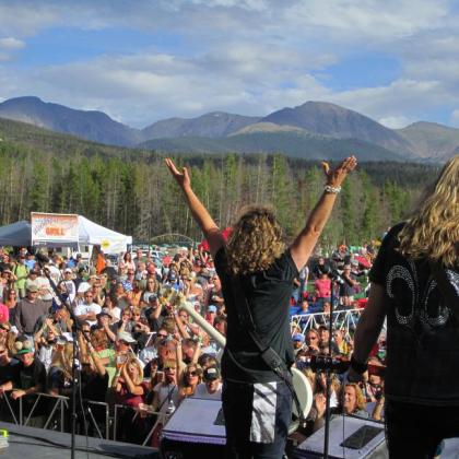 women on stage and crowd cheering