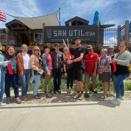 ribbon cutting and people smiling 