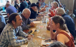 people sitting at a table enjoying lunch 