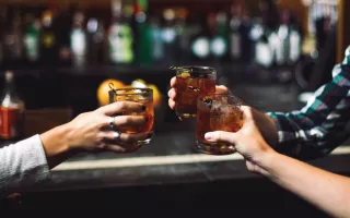 Toasting drinks at a bar