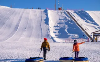  A couple walking towards a tubing hill
