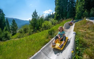 A kid and her father ride down Colorado's longest alpine slide