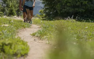 A hiking trail with hiker's feet in the distance