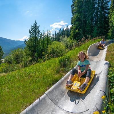 A kid and her father ride down Colorado's longest alpine slide