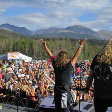 women on stage and crowd cheering