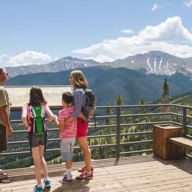 A family at a scenic overlook of Parry Peak