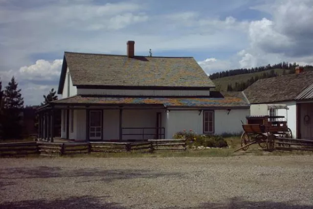 Find Cozens Ranch Museum along Hwy 40 -- a white with green historic building. Photo