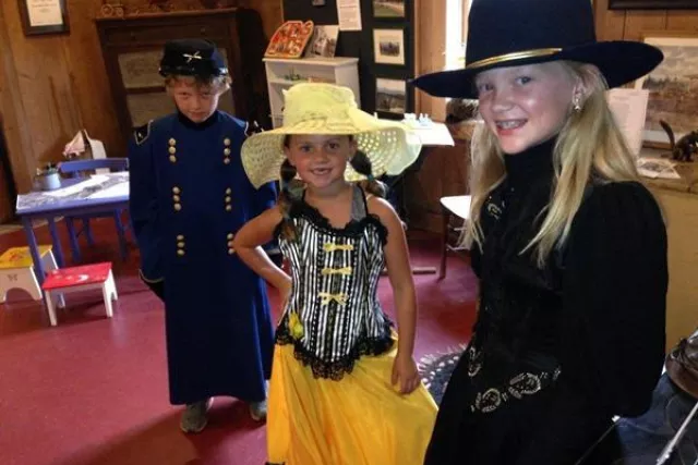 visitors trying on historic costumes at the museum Photo 2