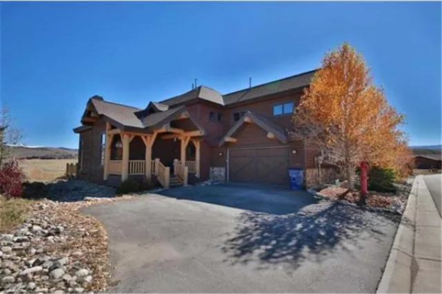 Elk Track has dramatic log accents, rustic wood floors, and a deck that overlooks the golf course. Photo 3