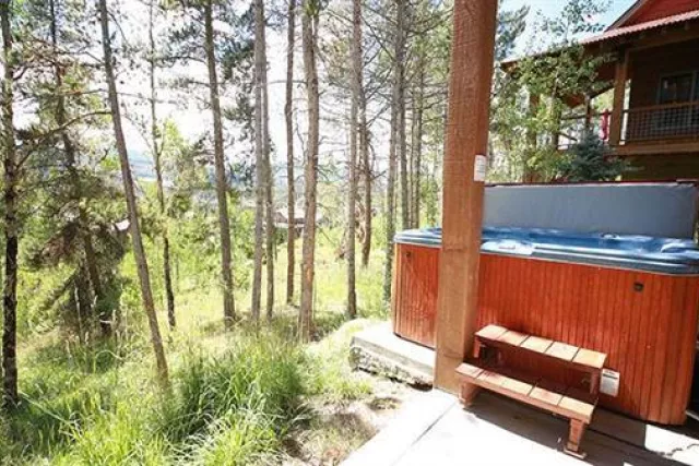 Enjoy the fresh mountain air, in the hottub at our Campfire cabin. Photo 5