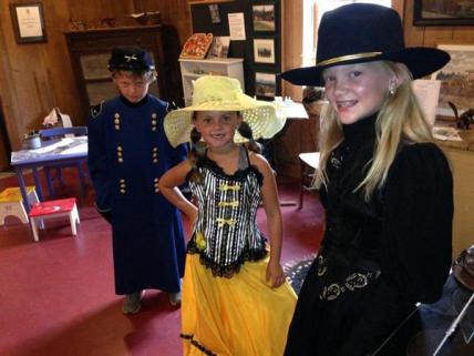 visitors trying on historic costumes at the museum