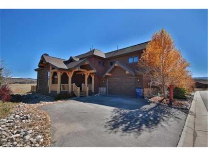 Elk Track has dramatic log accents, rustic wood floors, and a deck that overlooks the golf course.