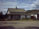 Find Cozens Ranch Museum along Hwy 40 -- a white with green historic building.