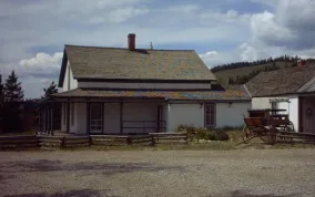 Find Cozens Ranch Museum along Hwy 40 -- a white with green historic building. Photo