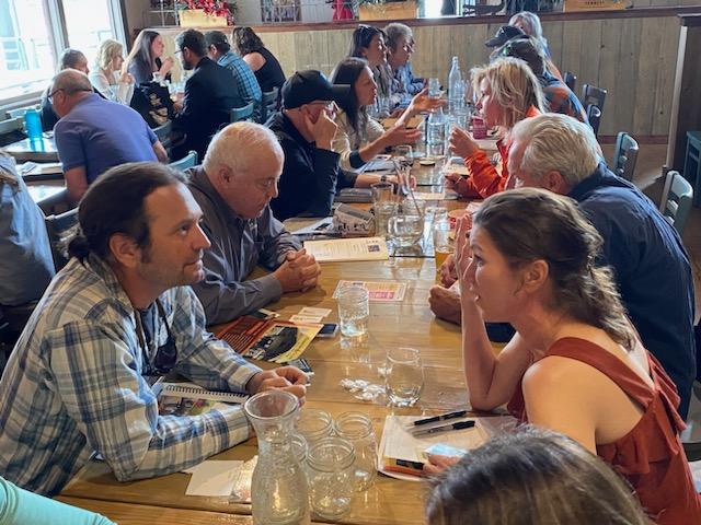 people sitting at a table enjoying lunch 