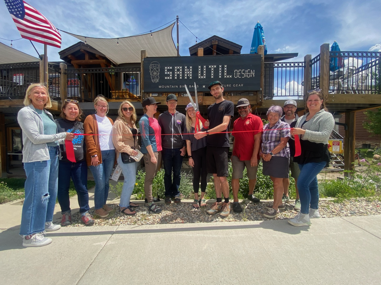 ribbon cutting and people smiling 