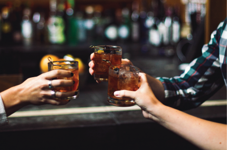 Toasting drinks at a bar
