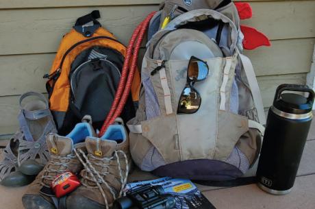 Hiking gear laid out in preparation for a summer trip