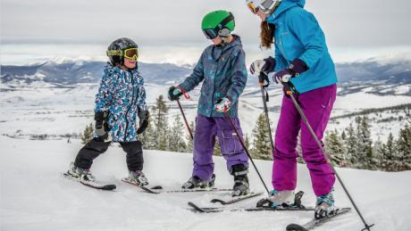 Family of skiers pausing to take in the view from Granby Ranch